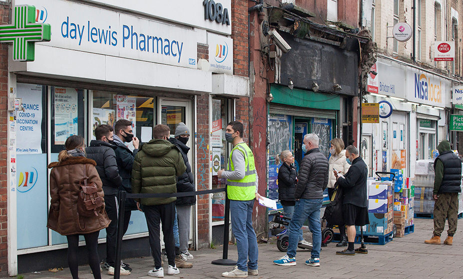 People queueing for booster jabs at Day Lewis Pharmacy on Brixton Hill, London