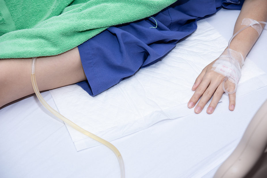 Catheter bag hanging under patient bed in hospital