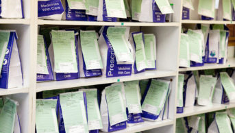 NHS prescription bags on a shelf