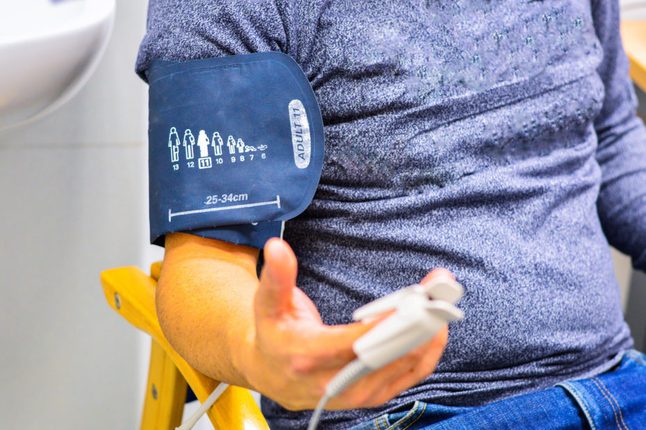Man wearing oximeter and blood pressure cuff