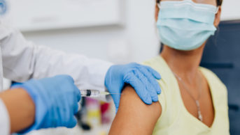 healthcare professional giving vaccination