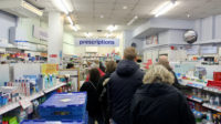 people queuing for pharmacy counter