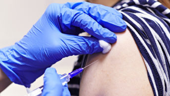 Close up of a flu vaccination in the arm of patient