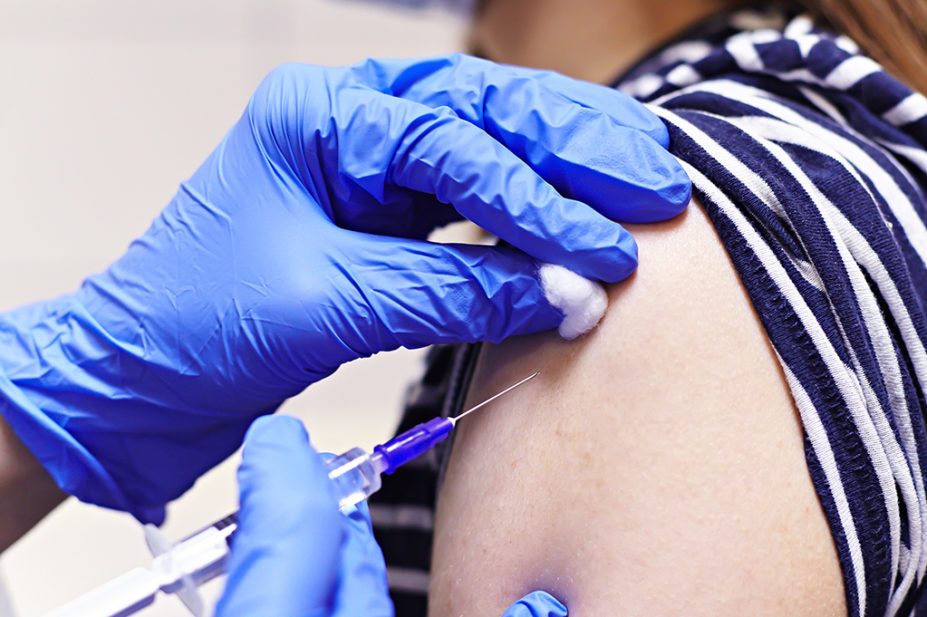 Close up of a flu vaccination in the arm of patient