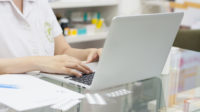 Laptop being used by a pharmacist in a pharmacy