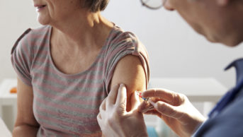 older woman receiving vaccination