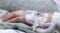 Hand with intravenous drip attached