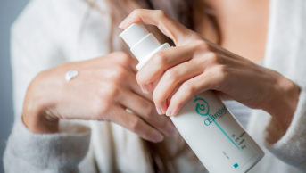 Woman applying oestrogen gel on her hands