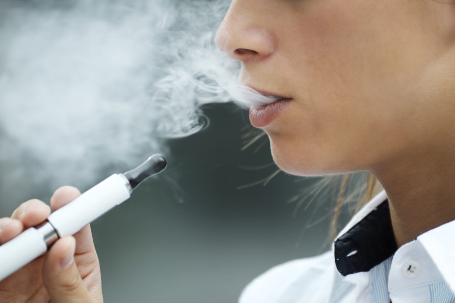 closeup of woman smoking e-cigarette