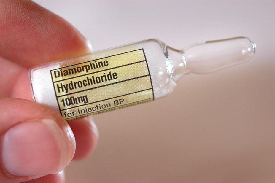A 100mg ampoule of diamorphine held in fingertips