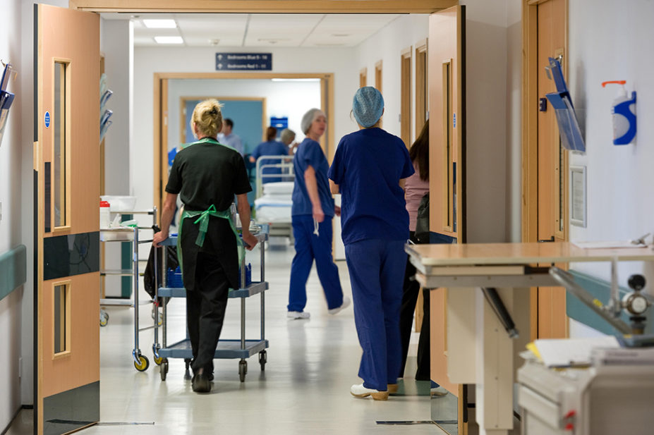 hospital corridor with staff walking down it