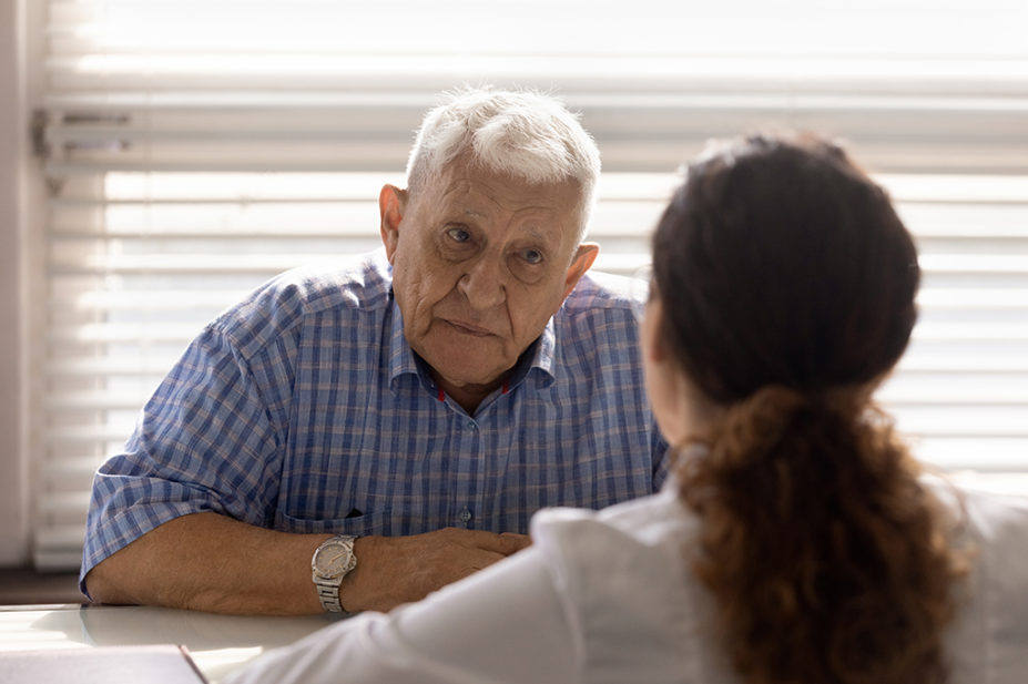 older man in consultation with pharmacist