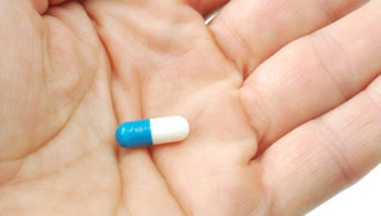 strattera pill in hand