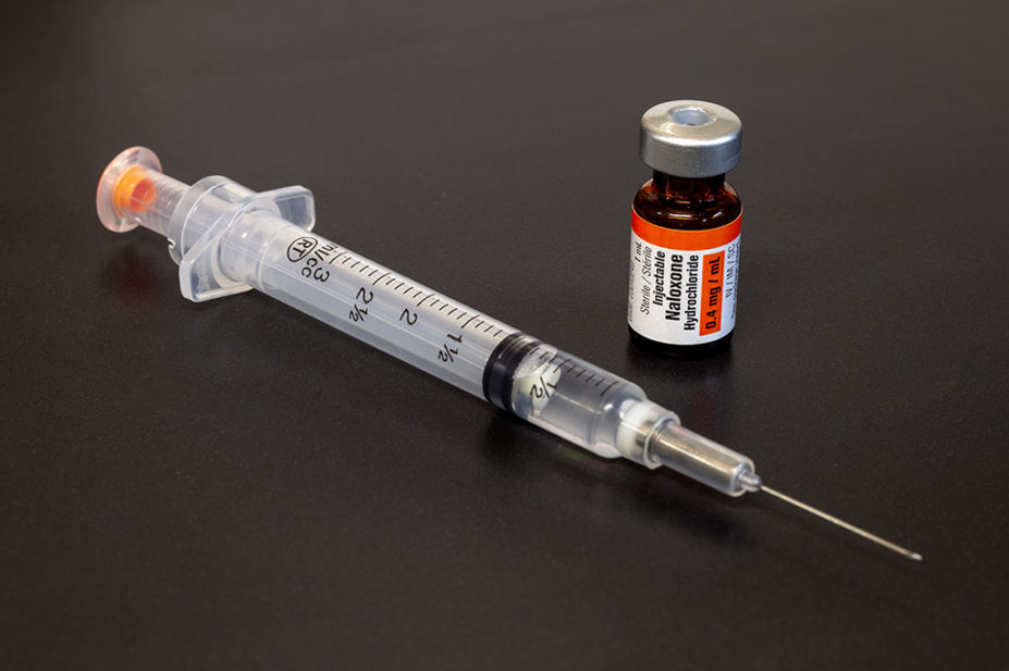 A vial of naloxone and a syringe