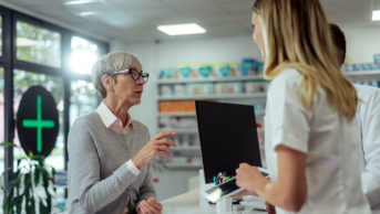 older woman at pharmacy counter