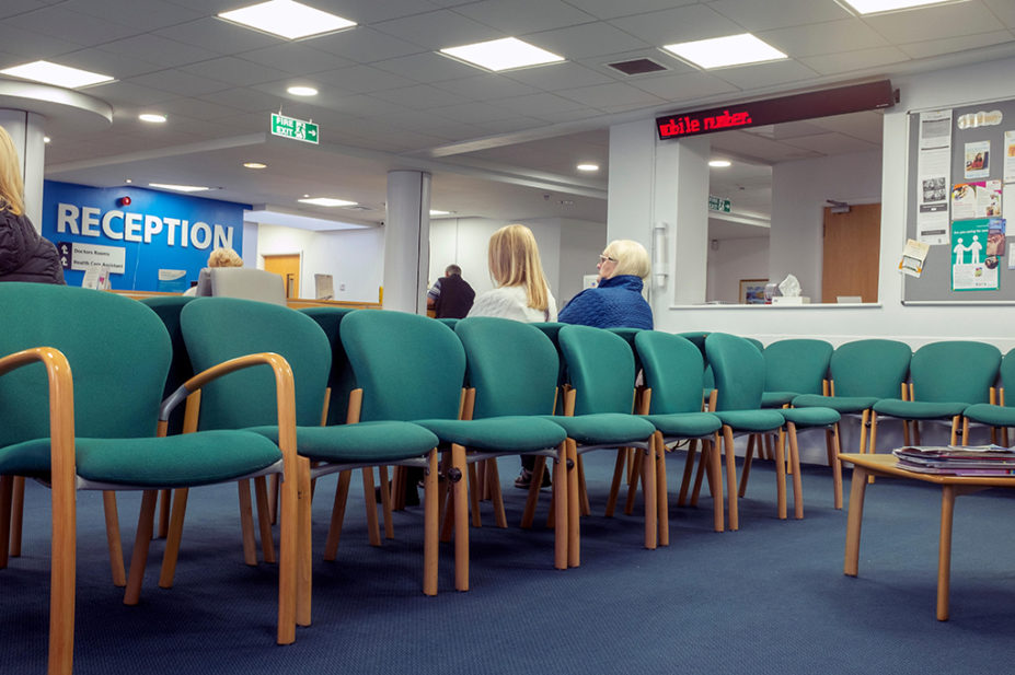 patients sitting in gp waiting room