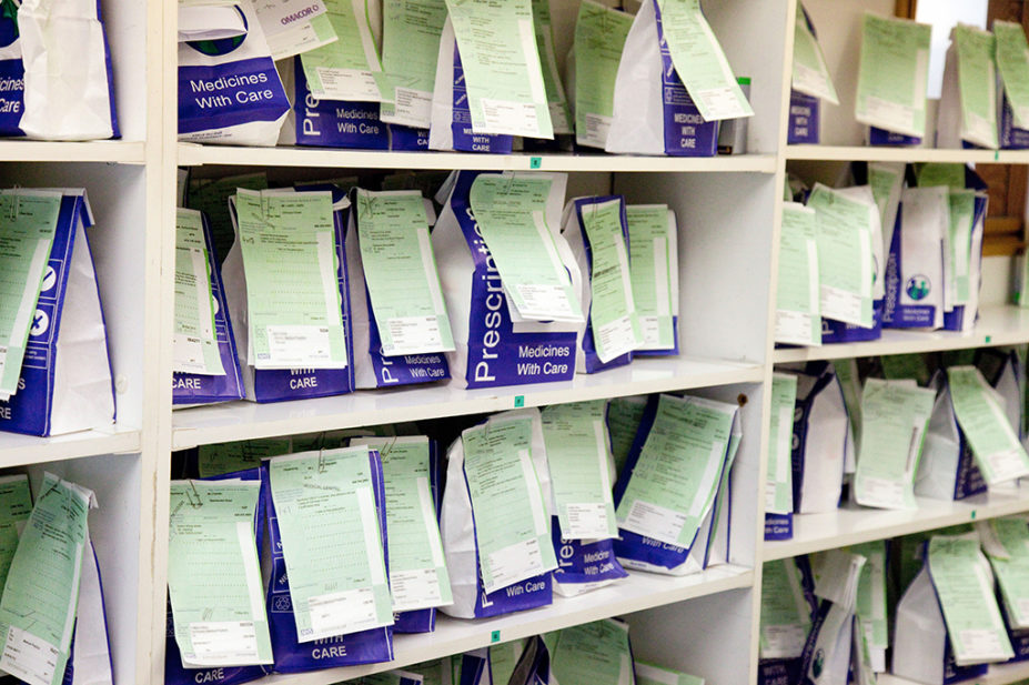 NHS Prescription medicines waiting to be collected on a chemist pharmacy shelves