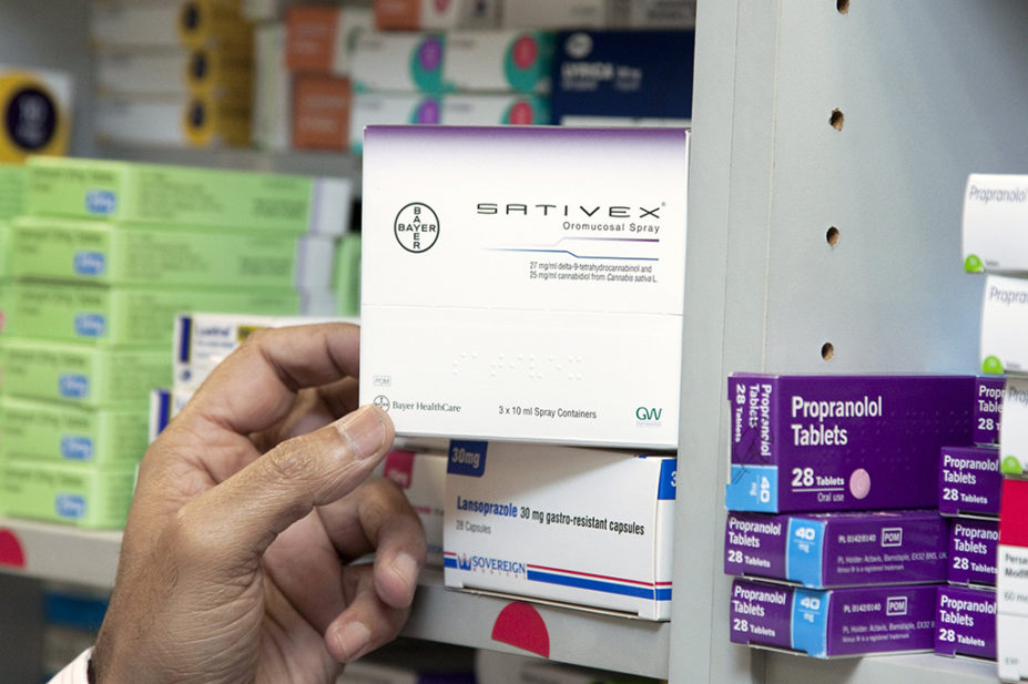 Pharmacist holding a box containing Sativex
