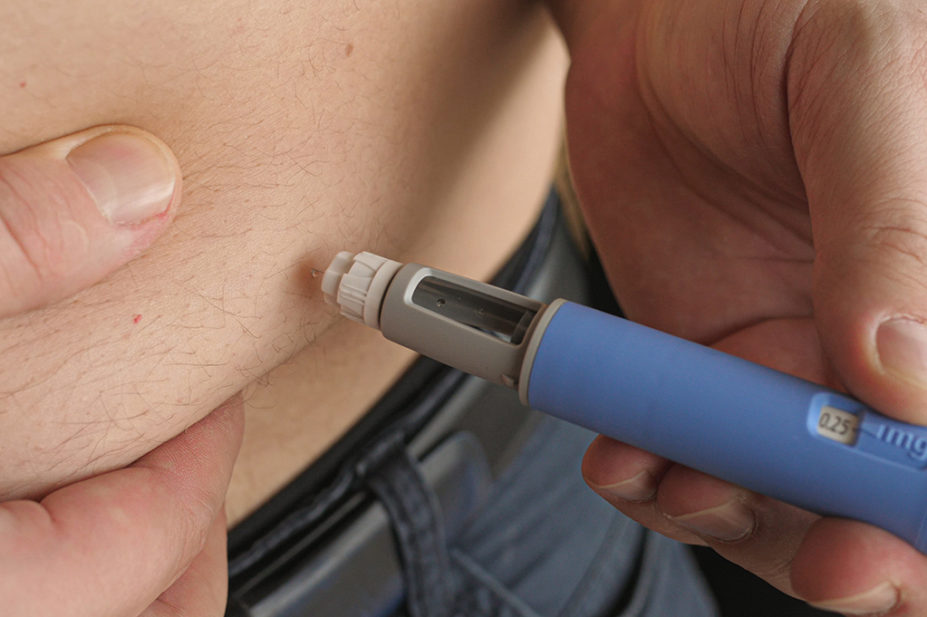 Man injecting semaglutide into his stomach