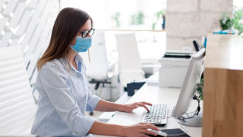 woman using computer at hospital desk
