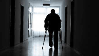 Disabled man in a hospital corridor