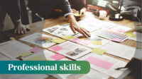 A person leans over a table with lots of papers and sticky notes arranged across, the words 