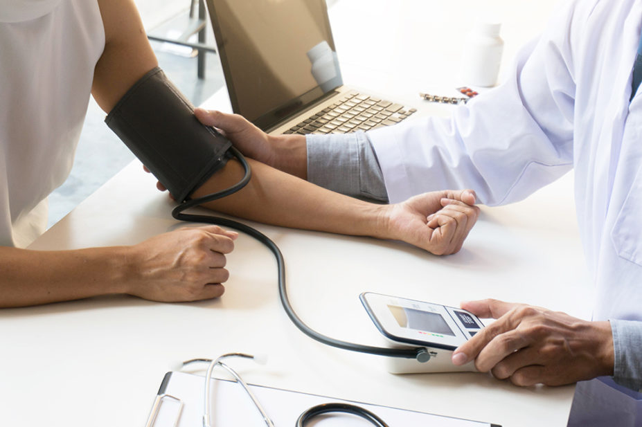 healthcare professional measuring blood pressure