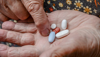 Older person taking pills