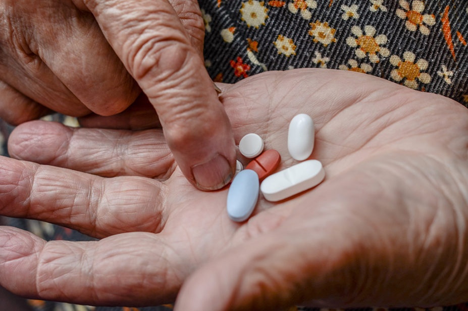 Older person taking pills