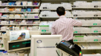 Pharmacy counter; UK Pharmacy interior; Boots the Chemist, the pharmacist working in the pharmacy, UK