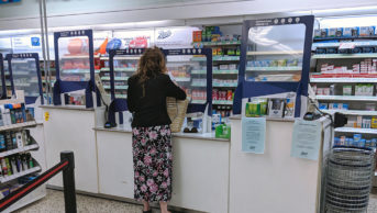 A woman at a pharmacy counter