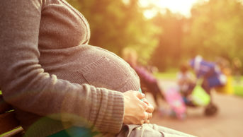 pregnant woman sitting on bench