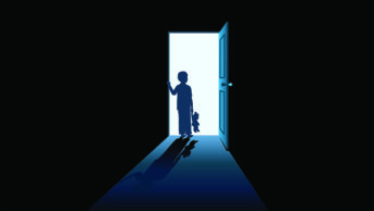 silhouette of young boy in doorway holding teddy bear