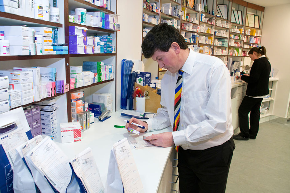 community pharmacist looking at medicine