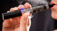 woman inhaling e-cigarette