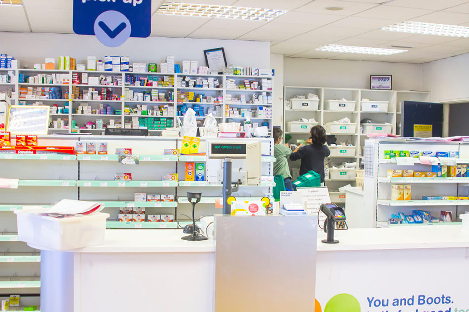 staff looking through prescription drawers in pharmacy