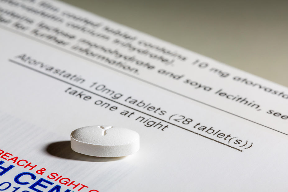 Atorvastatin tablet on a prescription box