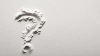 question mark in white powder