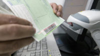 Pharmacist scanning a barcode on a prescription slip