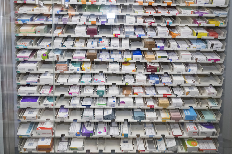 Large medicine cabinet filled with medicine boxes