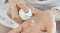 women dispensing oestrogen gel onto hand