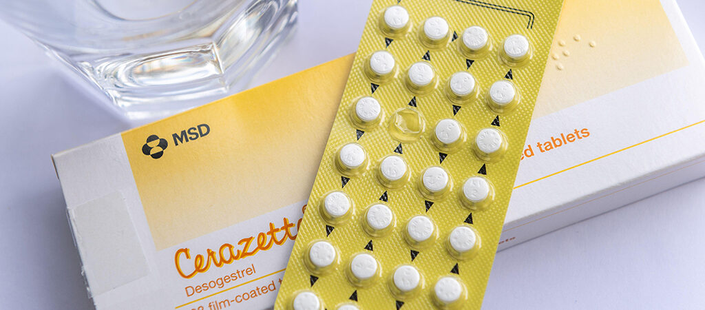cerazette pill pack on top of box with glass of water