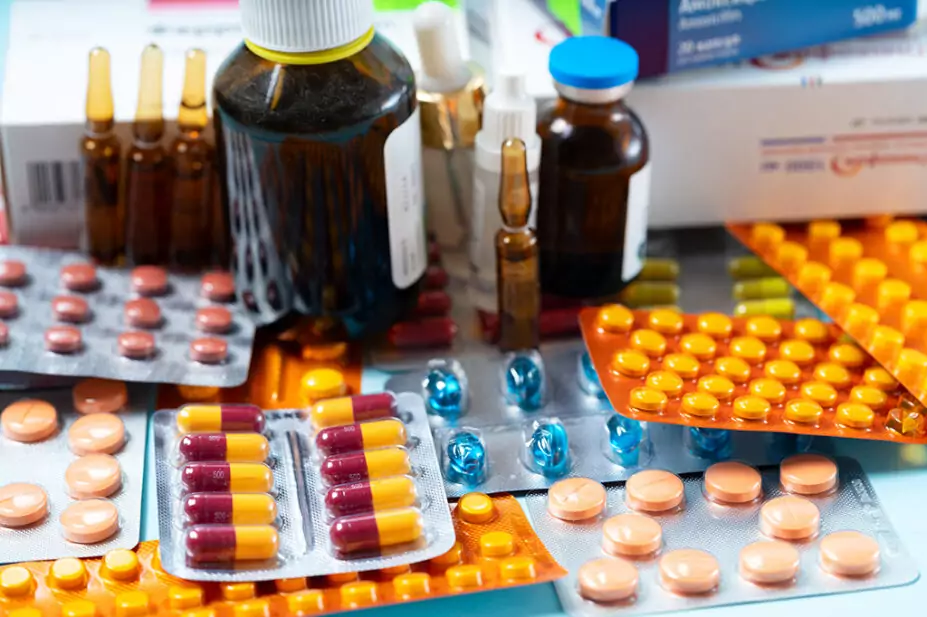 pile of tablets in blister packs, bottles and vials