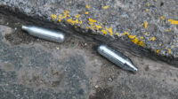 Two canisters on concrete