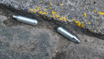 Two canisters on concrete