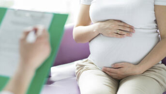 consultation between healthcare professional and pregnant woman
