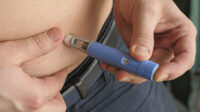 man injecting semaglutide into stomach