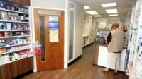 Community pharmacy interior, showing consultation room and counter