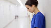 Stressed pharmacist in hospital corridor