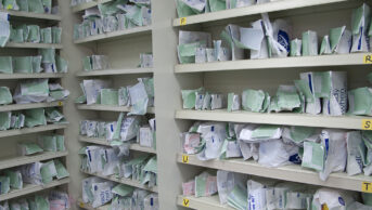 prescription bags on pharmacy shelves